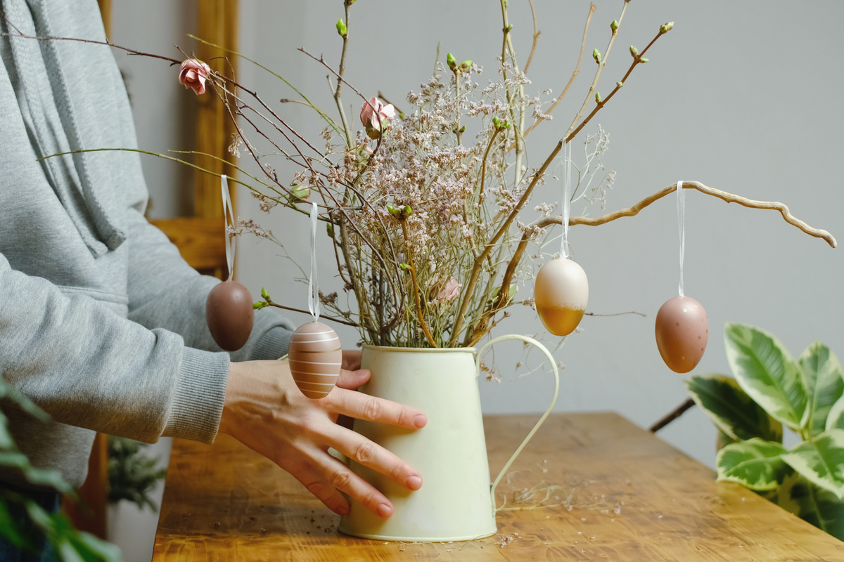 Spring Easter home interior. Woman makes Easter DIY decoration